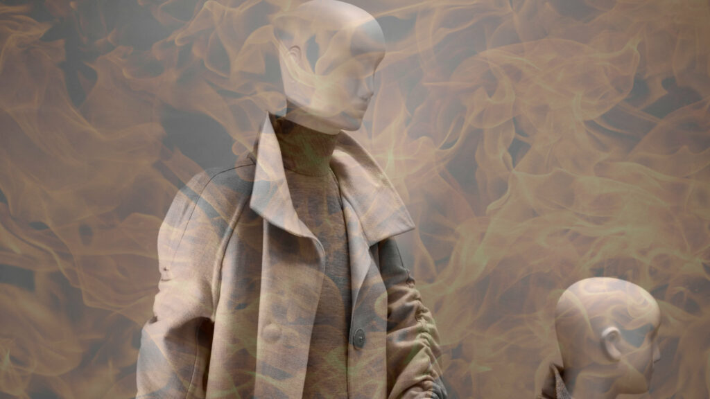 An abstract visualisation containing a fashion store mannequin and flames, showing the link between the clothing industry and industrial accidents that can cause casualties.
